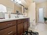 ACROSS THE HALLWAY FROM THE 3RD BEDROOM IS THE 3RD "POOL" BATH OFFERING ACCESS FROM THE INSIDE AND OUTSIDE.  THERE IS A SHOWER TO THE LEFT AND LARGE L