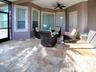 AROUND THE CORNER IS ANOTHER SEATING AREA, A STORAGE ROOM FOR ALL YOUR POOL EQUIPMENT, A POOL BATH AND THE SLIDING GLASS DOORS LEAD TO THE PRIMARY BED