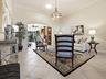 FROM THE FOYER, STEP INTO YOUR FORMAL LIVING ROOM THAT FLOWS INTO THE ADDED BONUS AREA AND FAMILY ROOM.