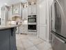 WALL OVENS AND A WALK-IN PANTRY WITH CUSTOM SHELVING AND POT FILLER!