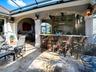 A GREAT PLACE FOR ENTERTAINING WITH THE SUMMER KITCHEN OFFERING AN ALFRESCO GRILL AND REFRIGERATOR.