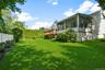 Private level yard with soft green grass and plantings