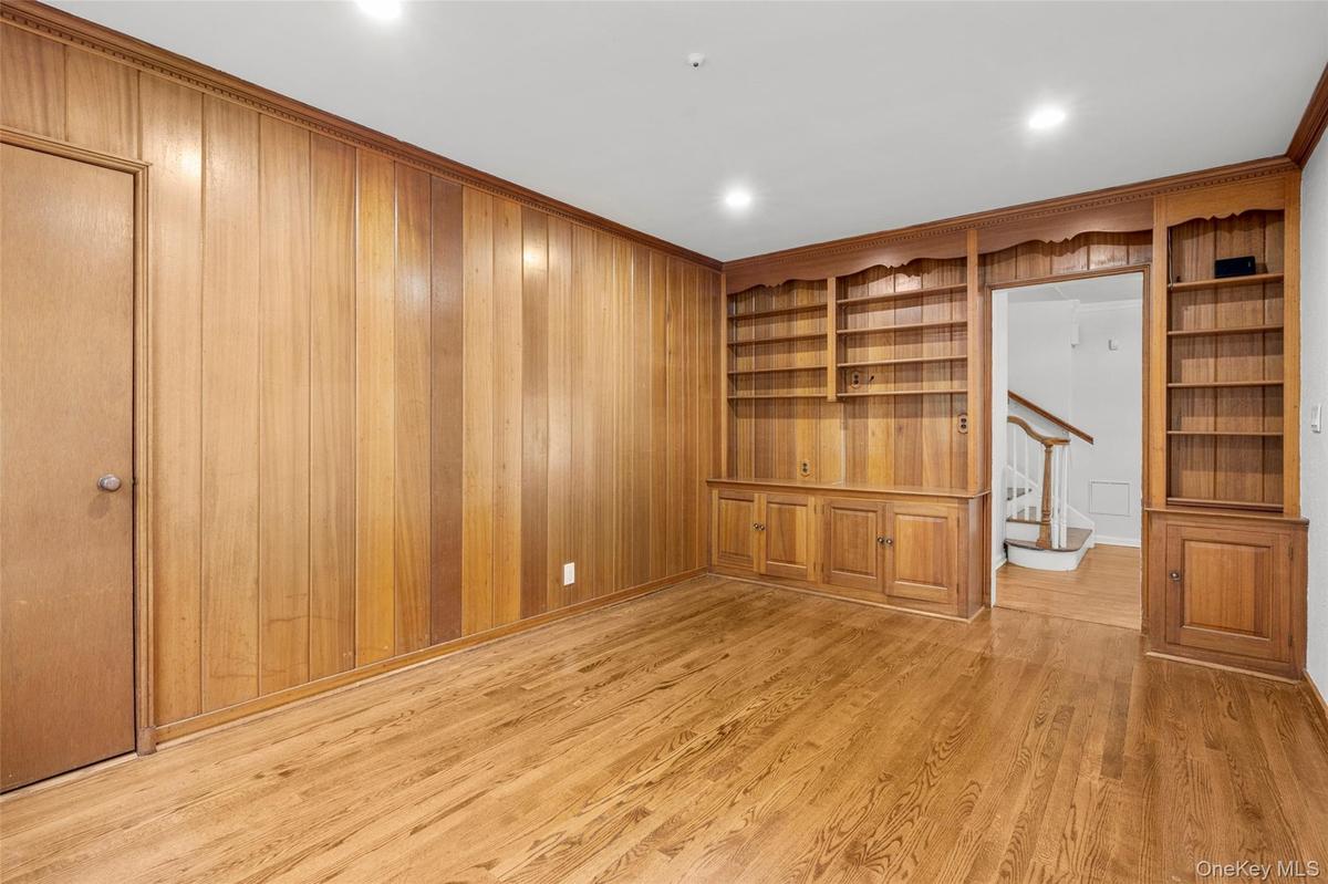 1st floor den with built-in bookcases provides a perfect home office, den or guest room