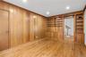 1st floor den with built-in bookcases provides a perfect home office, den or guest room