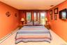 Carpeted room featuring multiple windows, baseboard heating, and warm-toned walls
