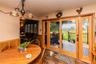 Wood-finish flooring, half-wall wainscoting, and patterned wallpaper