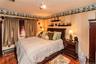 Wood-finish flooring with a decorative border and track lighting