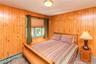 Wood-paneled walls and ceiling-mounted light fixture