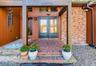 Brick and vertical wood siding exterior with a covered entry