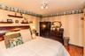Wood-finish flooring, built-in wall shelves, and a decorative wall border
