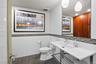 Powder room off entrance foyer with custom storage cabinetry