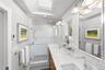 Sun filled renovated primary bathroom with beautiful finishes and many special features