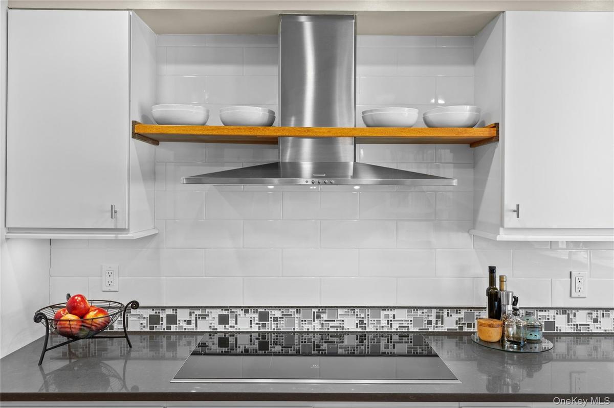 Furniture grade custom cabinetry with tile backsplash and every amenity