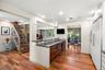 Kitchen peninsula features quartz countertops, wine bar and prep sink