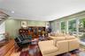 Living room with floor to ceiling windows recessed lighting and Kempas HW floors throughout