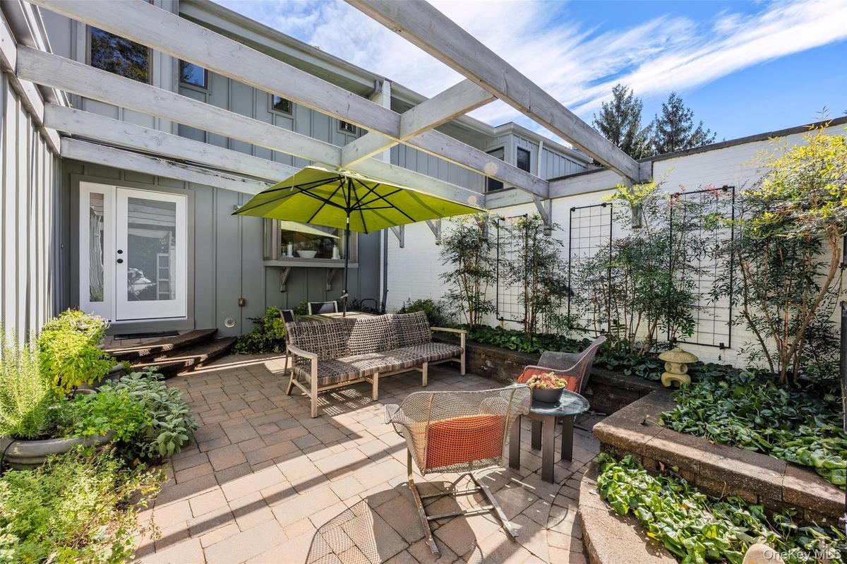 Private front courtyard with brick patio and lovely gardens