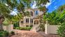 Mizner inspired architecture and lush tropical landscaping create an impressive introduction to this private bayfront residence.