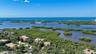 Sweeping aerial views showcase the extraordinary natural setting along Little Sarasota Bay and the surrounding coastal landscape.