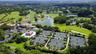 An aerial perspective highlights the expansive golf, lake and residential setting of this renowned private community.