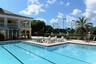 A beautifully maintained club pool provides another inviting option for leisure and recreation.