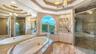A spacious glass enclosed shower and soaking tub complement the beautifully appointed primary suite.