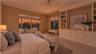 Expansive windows bring dramatic sunset colors directly into the private primary retreat.
