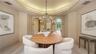 The dining room's graceful proportions and architectural detailing create an inviting space for memorable gatherings.