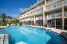 NOTE the circular staircases that runs from the unit balcony down to the pool area and private lounge area.