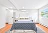 Bedroom featuring wood-finish flooring and a bright window