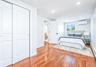 Hardwood flooring throughout featuring recessed lighting, a window with exterior views, and an individual climate control unit