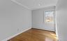 Wood-finish flooring, single window, recessed lighting, white baseboards, and crown molding