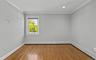 Hardwood flooring, recessed ceiling lighting, crown molding, double-hung window, and baseboard heating