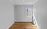 Recessed ceiling lighting, crown molding, wood-finish flooring, single window, and a wall-mounted radiator