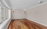 Cherry wood finish flooring, base and crown moldings, large bay window, recessed lighting