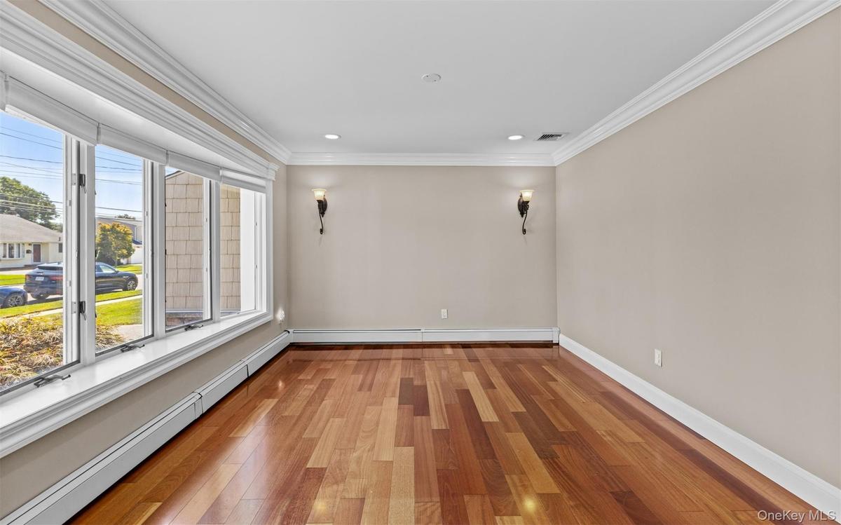 Cherry wood finish flooring, base and crown moldings, large bay window, recessed lighting