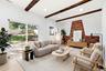 Virtually staged. Exposed ceiling beams, brick fireplace, wood-finish flooring, recessed lighting, and sliding glass door to yard