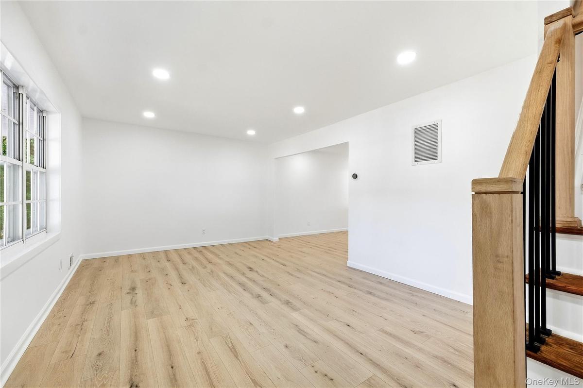 Wood-finish flooring throughout, recessed lighting, and a window with natural light