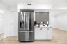 Stainless steel French door refrigerator with bottom freezer and integrated ice/water dispenser. Wine/coffee bar.