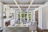 Coffered ceiling with wood-finish beams, and wood burning fireplace.
