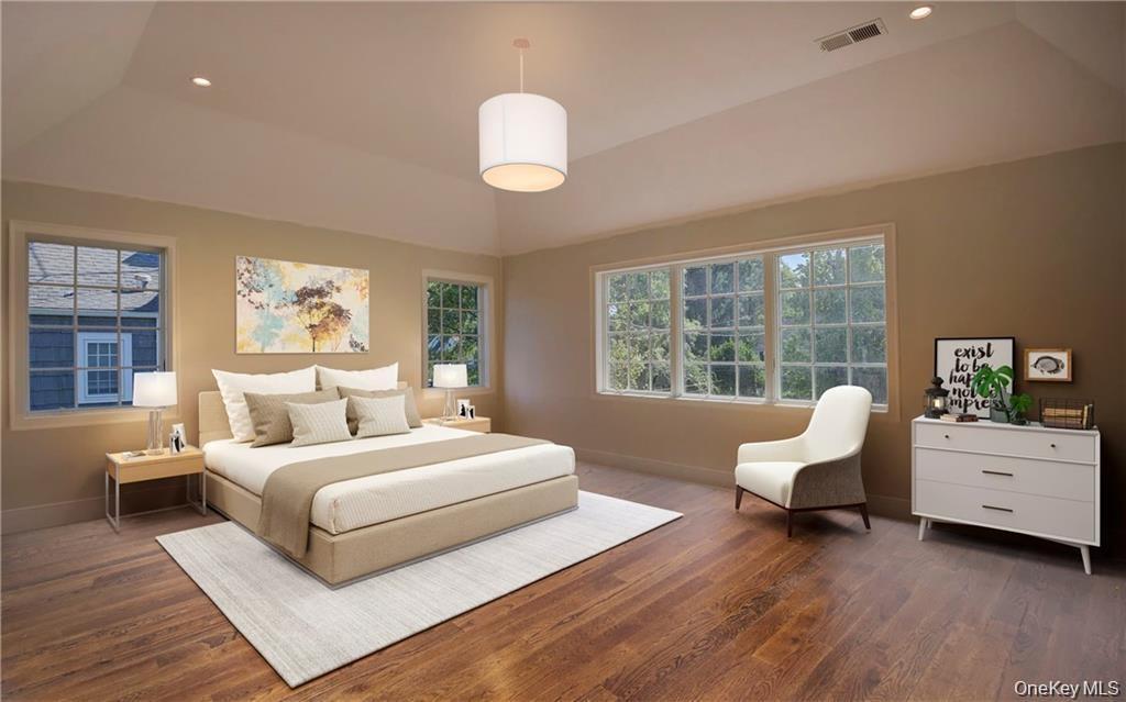 Sample of king-size primary bedroom upstairs with tray ceiling, sitting area, and walk-in closet