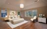Sample of king-size primary bedroom upstairs with tray ceiling, sitting area, and walk-in closet