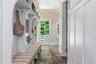 Built-in storage cubbies, half bath and walk-in pantry with garage access