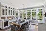 Built-in cabinetry with glass panel doors, integrated beverage cooler, and waterviews.