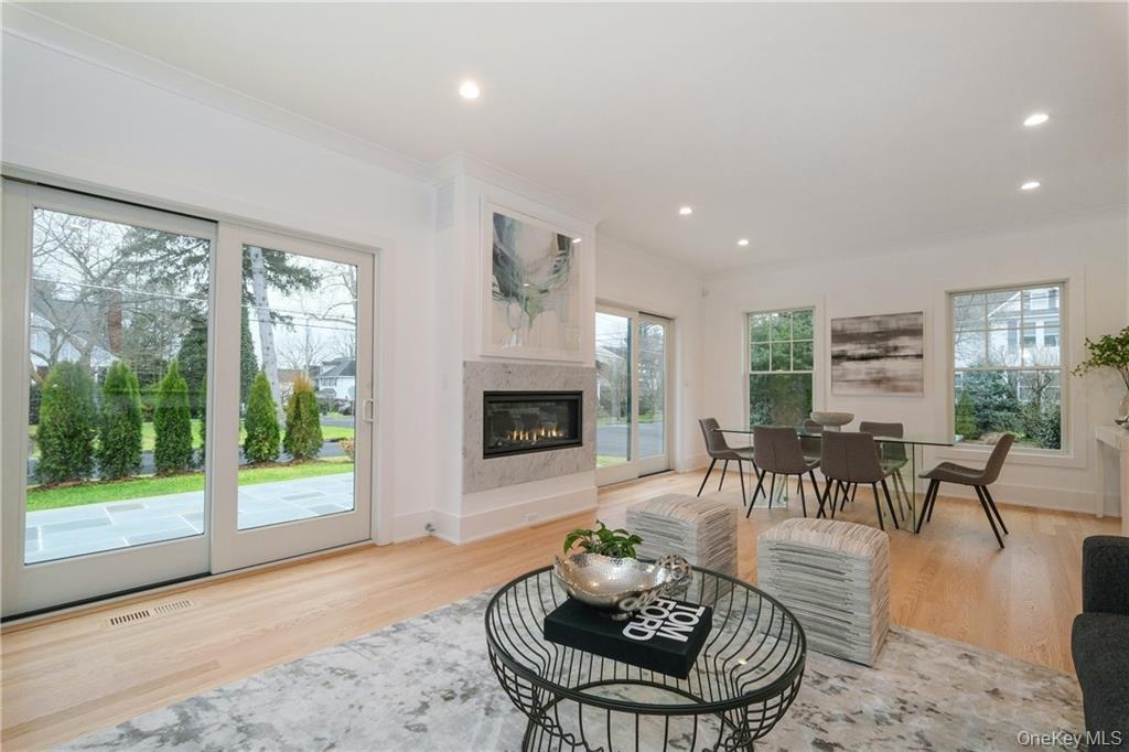 Family room from another home by this builder showing fireplace as focal point. Sliders to stone patio seamlessly integrate the indoor and outdoor spa