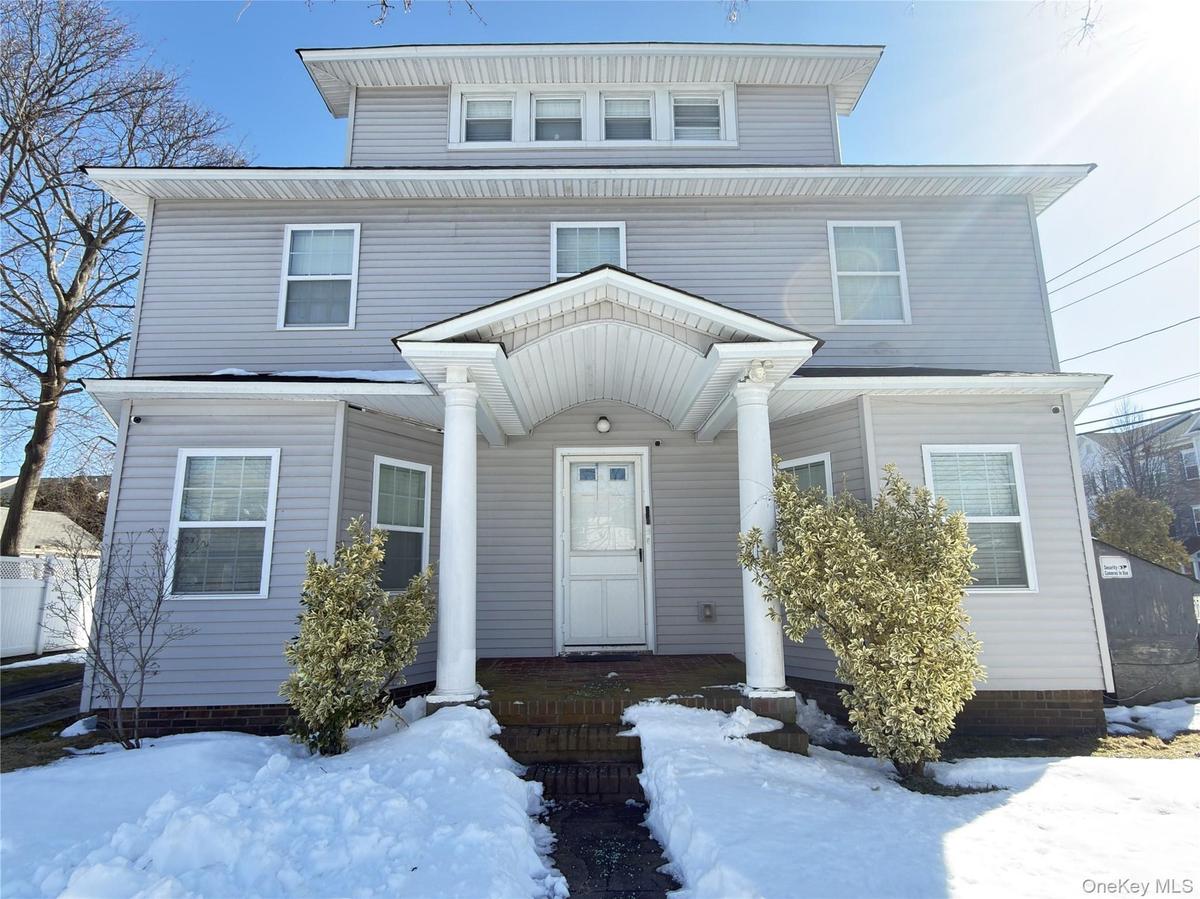 American foursquare style home featuring a porch