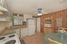Lower Level Eat in Kitchen, Electric Stove, Dishwasher, Refigerator Ceiling Fan. Tiled Floor with access to Laundry Room & Sep. Door to Yard.