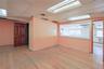 Empty room featuring light wood-type flooring and a drop ceiling