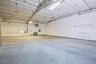Garage featuring a heating unit and electric panel