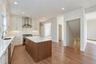 Virtually Staged - Kitchen. First Floor will have hardwoods. Kitchen cabinets in white/dove color. Island will be similar to the hardwoods.