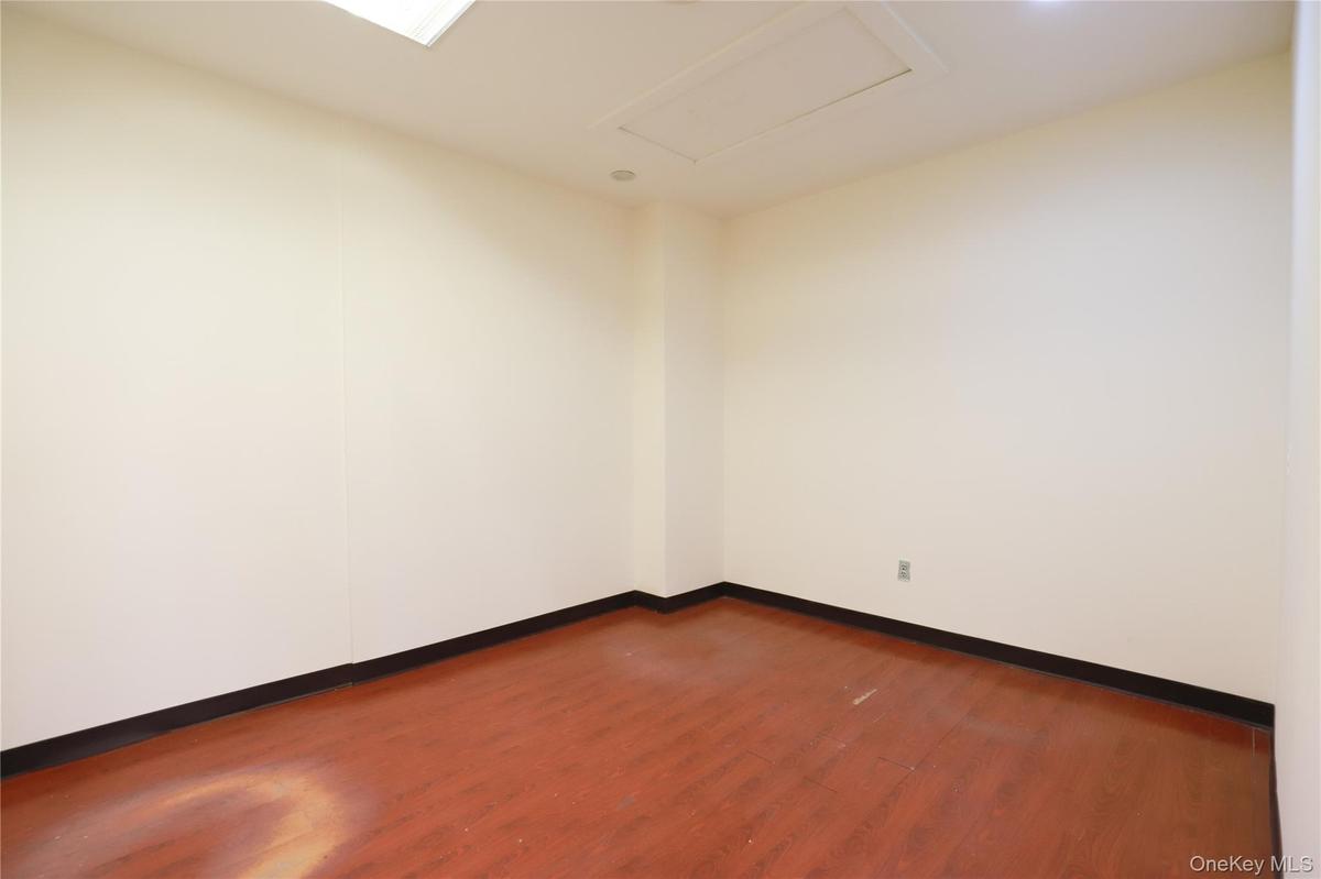 Light-colored walls, wood-finish flooring, and recessed ceiling lighting